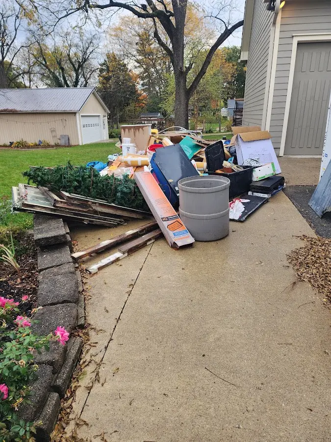 Dumpster being loaded with debris for 3 Yard Dumpster Rental in Middlefield